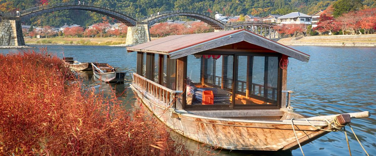 Boat and Kintai Bridge over Nishiki river in Iwakuni, Yamaguchi prefecture, Japan