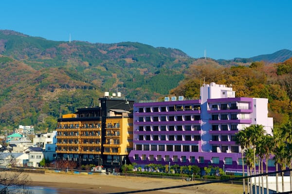 Toi Beach featuring a sandy beach, mountains and a coastal town