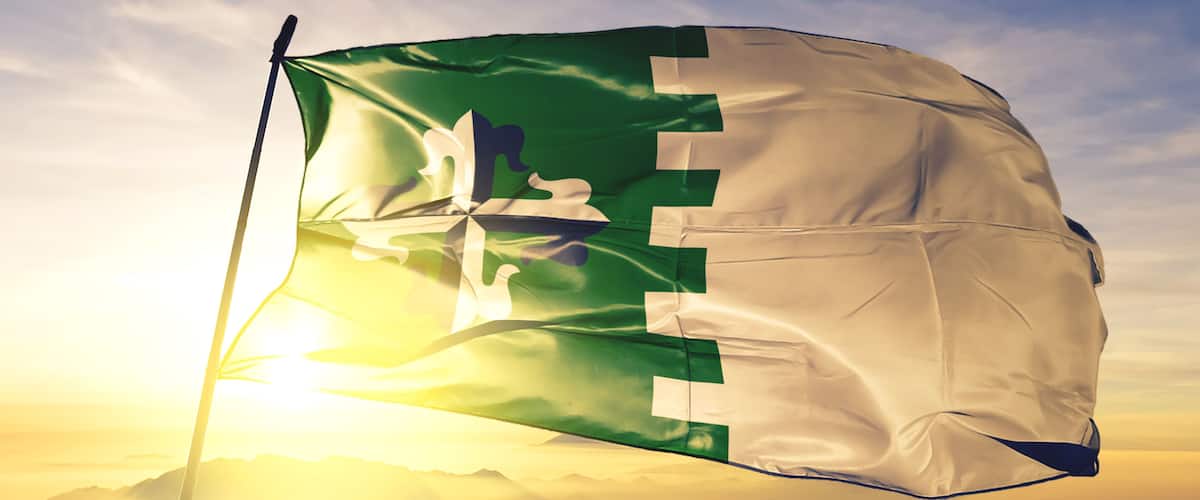 Guaynabo municipality of Puerto Rico flag waving on the top sunrise mist fog