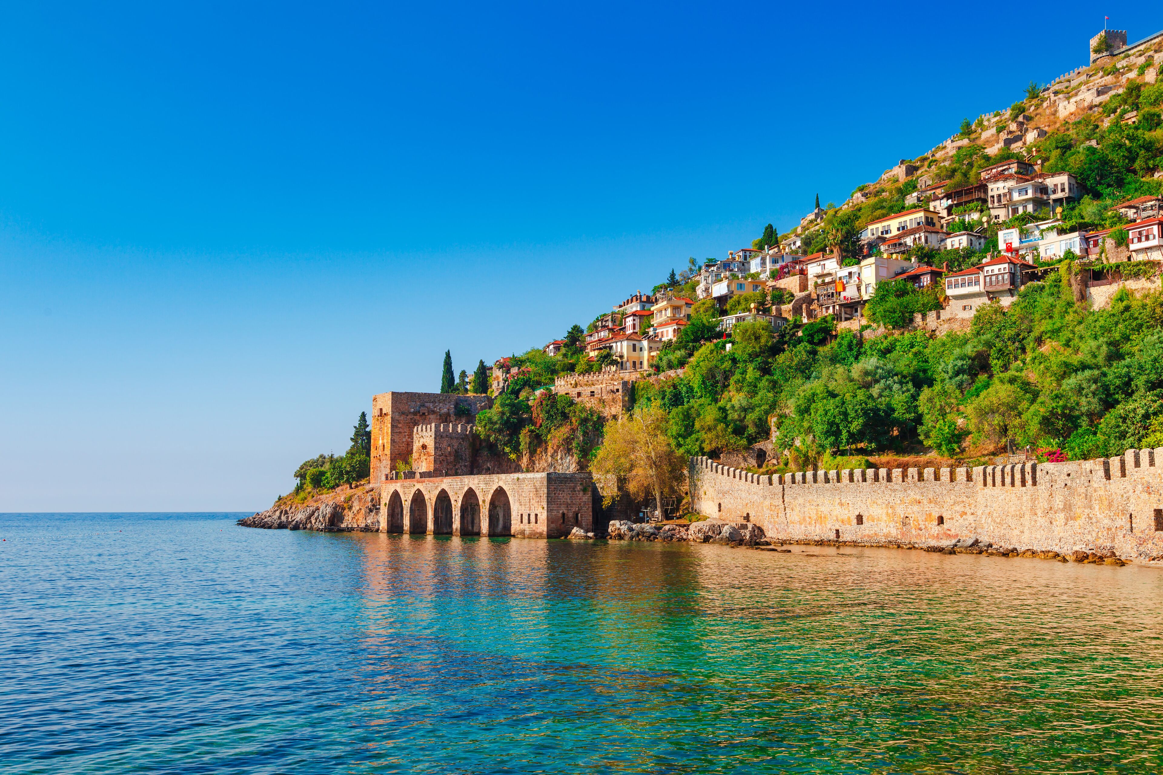 Landscape of ancient shipyard near of Kizil Kule tower in Alanya peninsula, Antalya district, Turkey, Asia. Famous tourist destination with high mountains. Part of ancient old Castle.