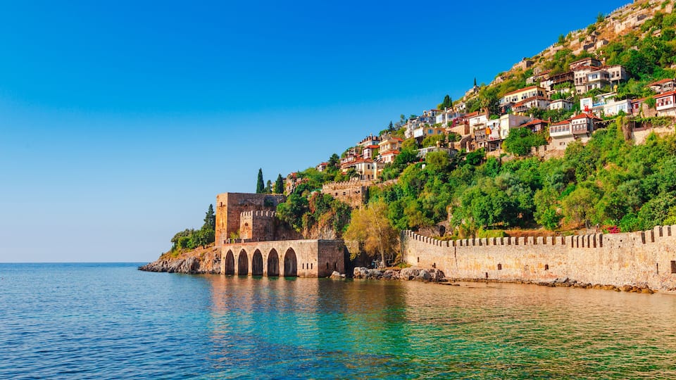 Landscape of ancient shipyard near of Kizil Kule tower in Alanya peninsula, Antalya district, Turkey, Asia. Famous tourist destination with high mountains. Part of ancient old Castle.