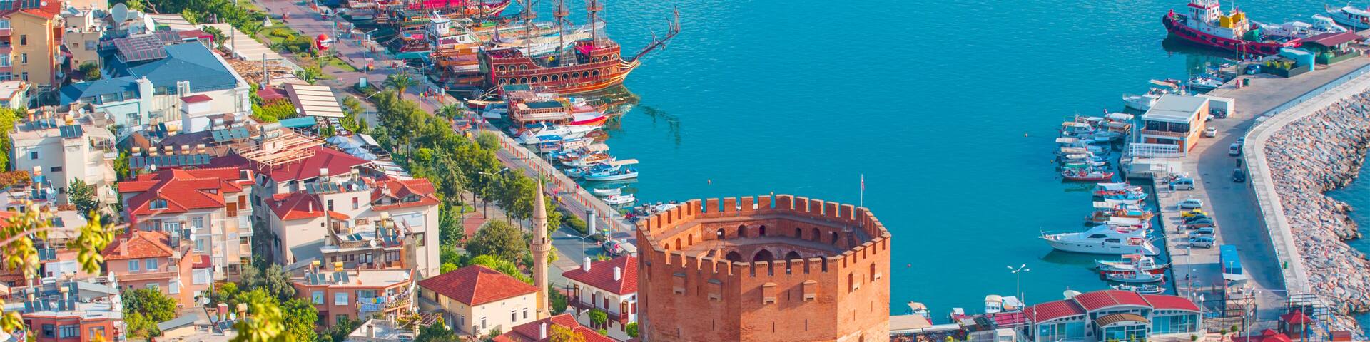 Landscape with marina and Kizil Kule tower in Alanya peninsula, Antalya district, Turkey
