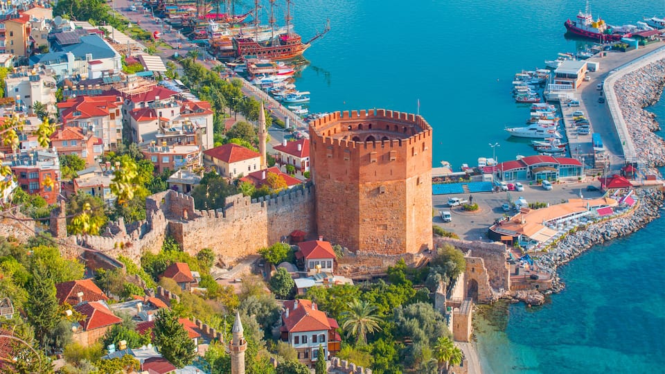 Landscape with marina and Kizil Kule tower in Alanya peninsula, Antalya district, Turkey