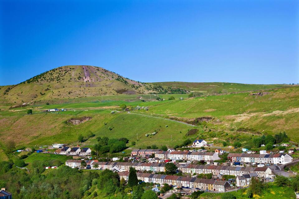 A hillside with a small village at its base.
