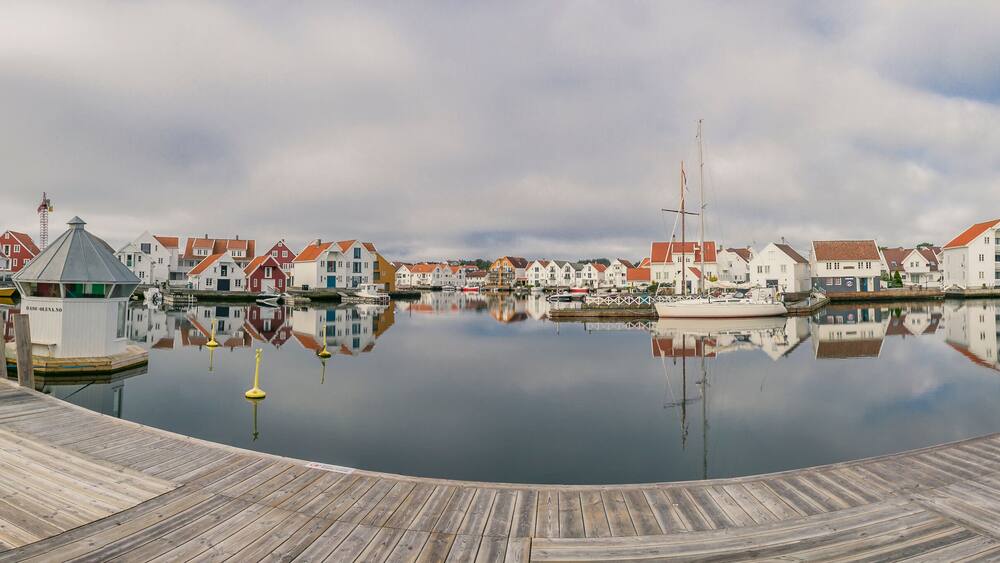 Houses and boats are reflected in the water