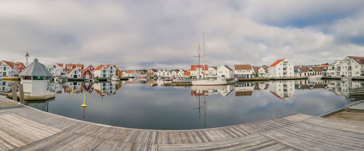 Houses and boats are reflected in the water