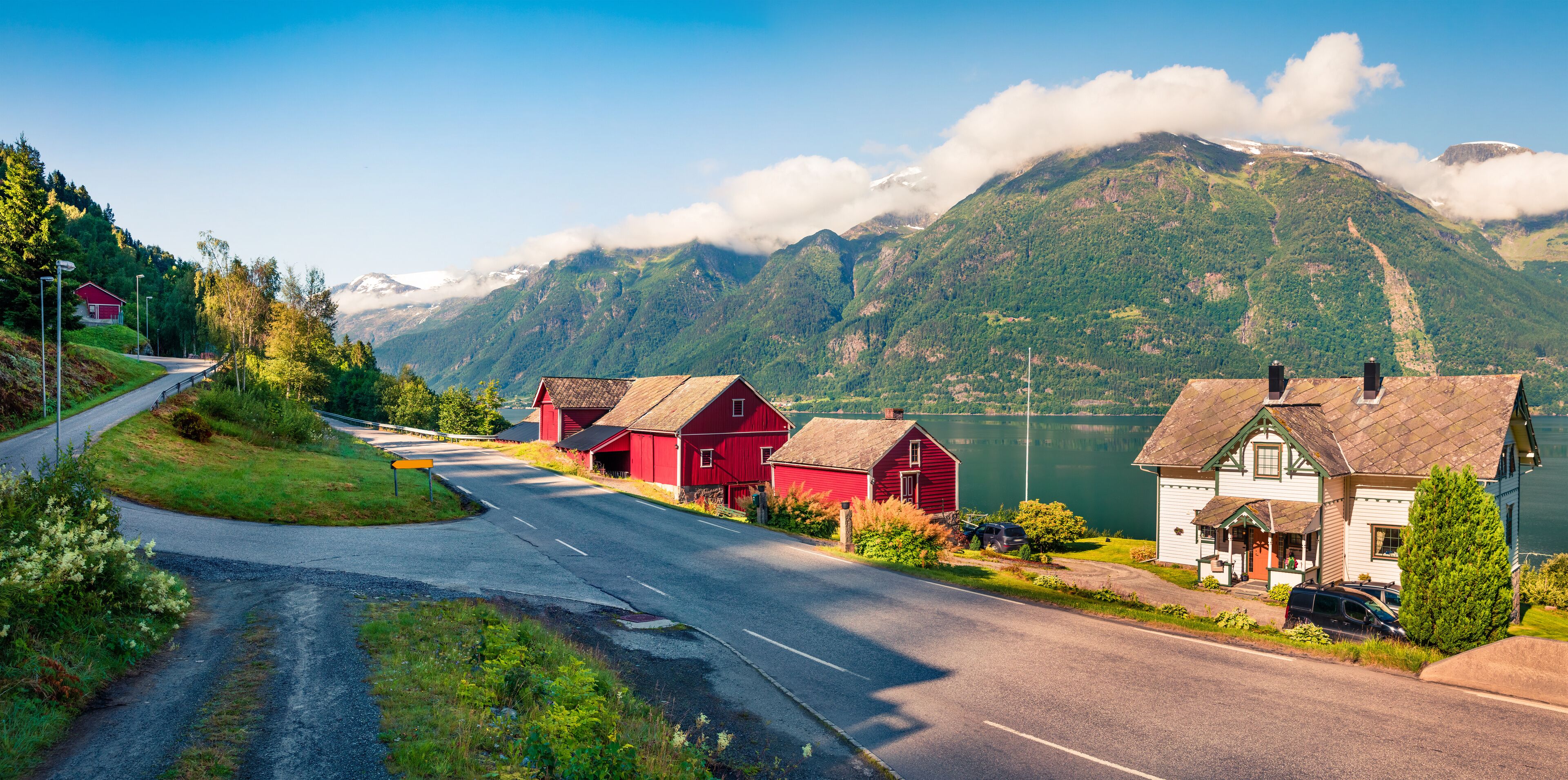Sunny summer panorama of the Lofthus village in Ullensvang municipality which is located in the Hardanger region of Hordaland county, Norway. Beauty of countryside concept background.