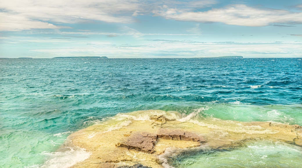 Panorama view of summer Georgian bay at Tobermory Ontario, Canada. Lake Huron and turquoise blue green transparent crystal clear water with rocky bottom formations. Indian Head Cove landscape.