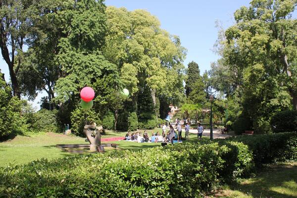 Group of people seat on the Giardini della Biennale publick park in venice, Italy