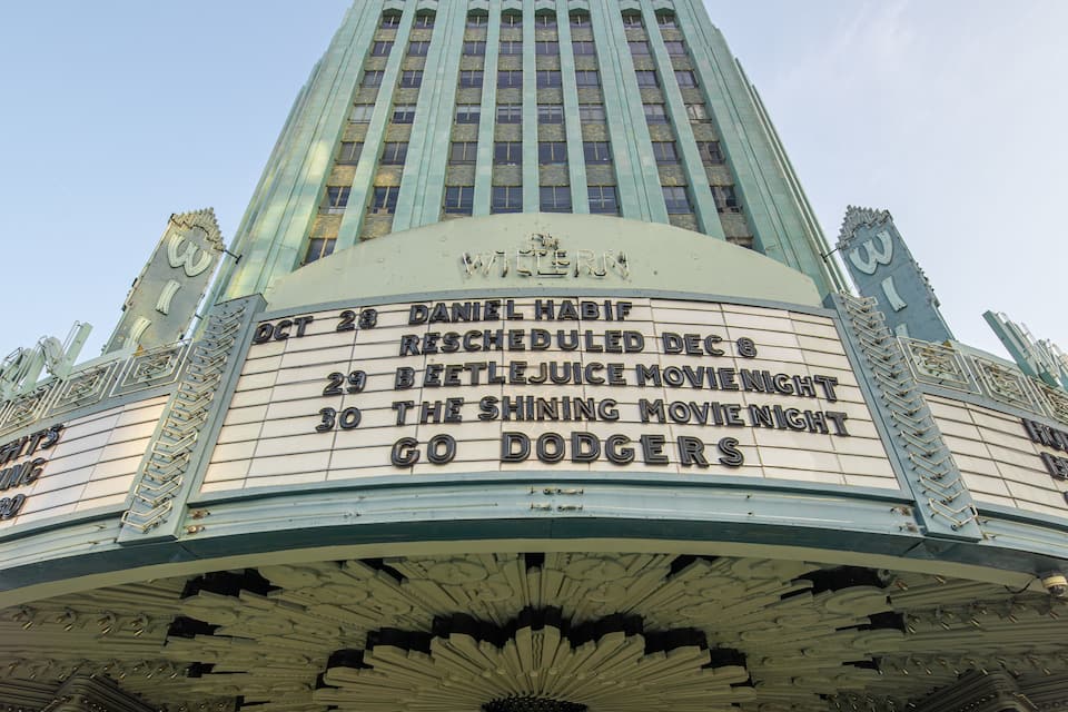 A theater marquee with movie listings.