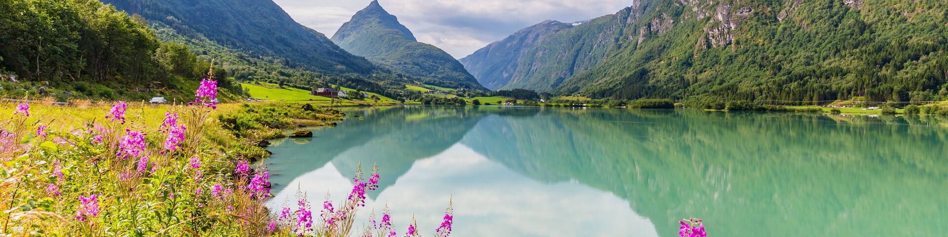Mountain panorama with mountain Eggenipa reflecting in a lake in Gloppen along highway E39 in Sogn og Fjorden county in Norway