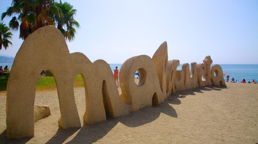 Malagueta Beach showing a sandy beach and signage