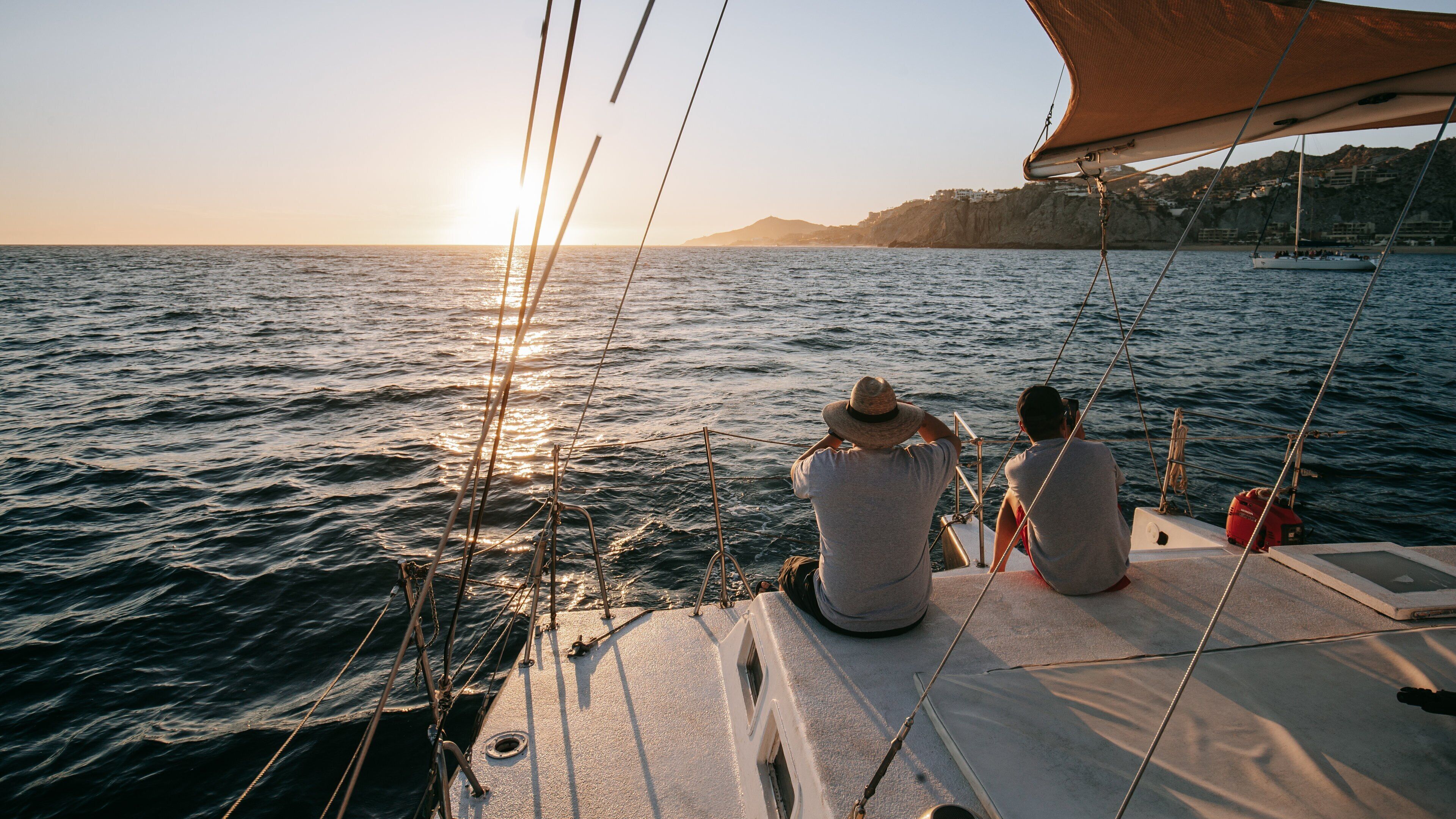 Cabo San Lucas Bay which includes general coastal views, a sunset and boating