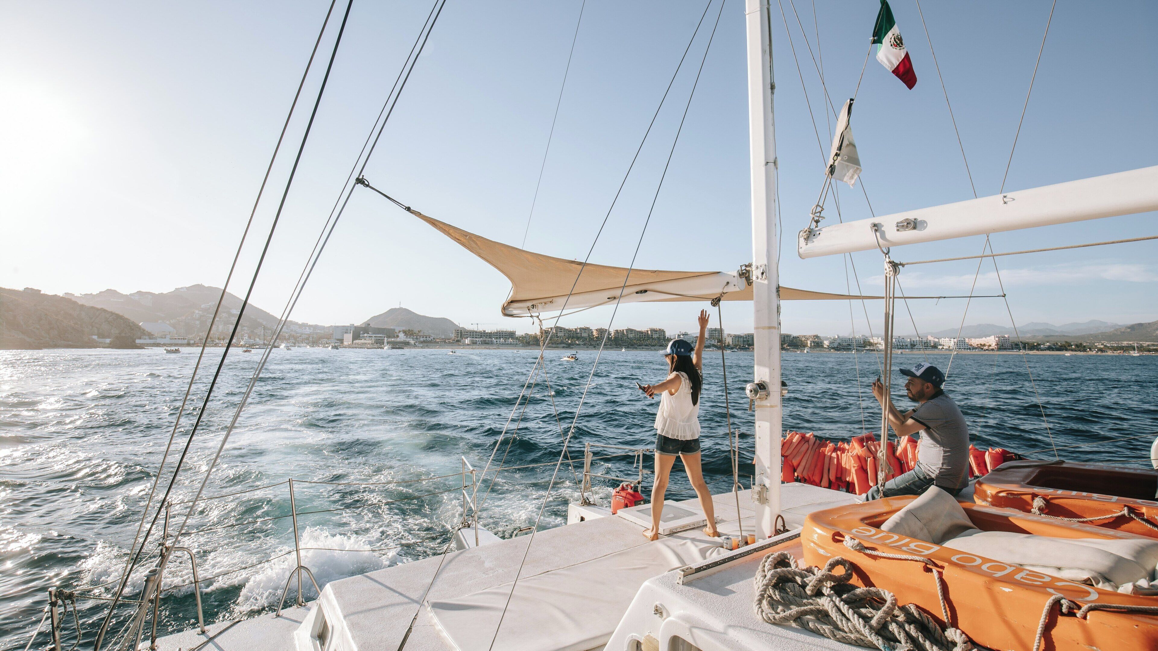 Sailing through Cabo San Lucas Bay with stunning views of Baja California Sur and vibrant ocean waves during a sunny afternoon