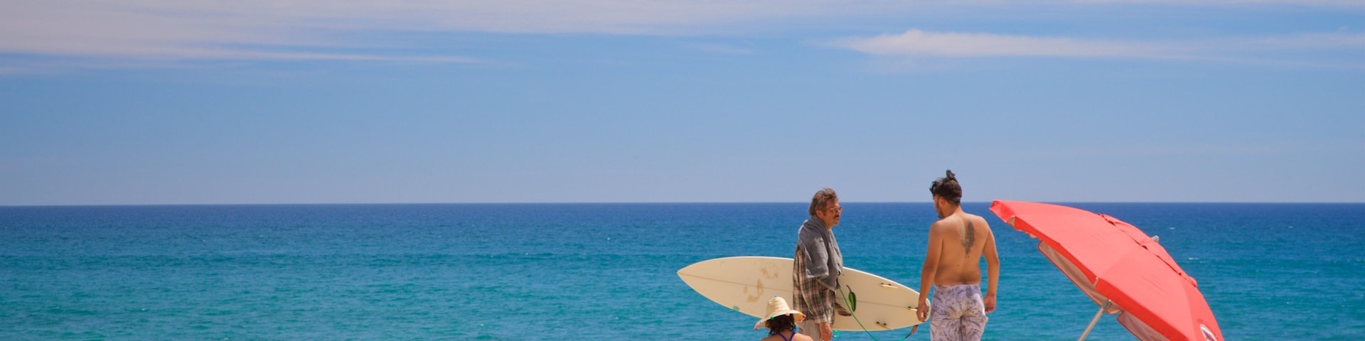 Costa Azul Beach showing general coastal views and a sandy beach as well as a small group of people