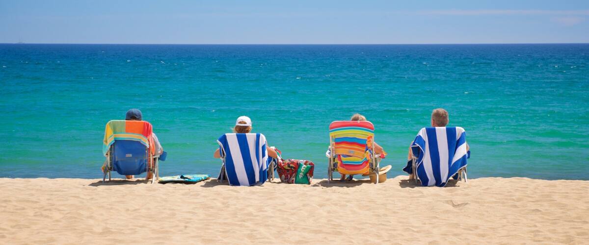 Costa Azul Beach which includes general coastal views and a beach as well as a small group of people