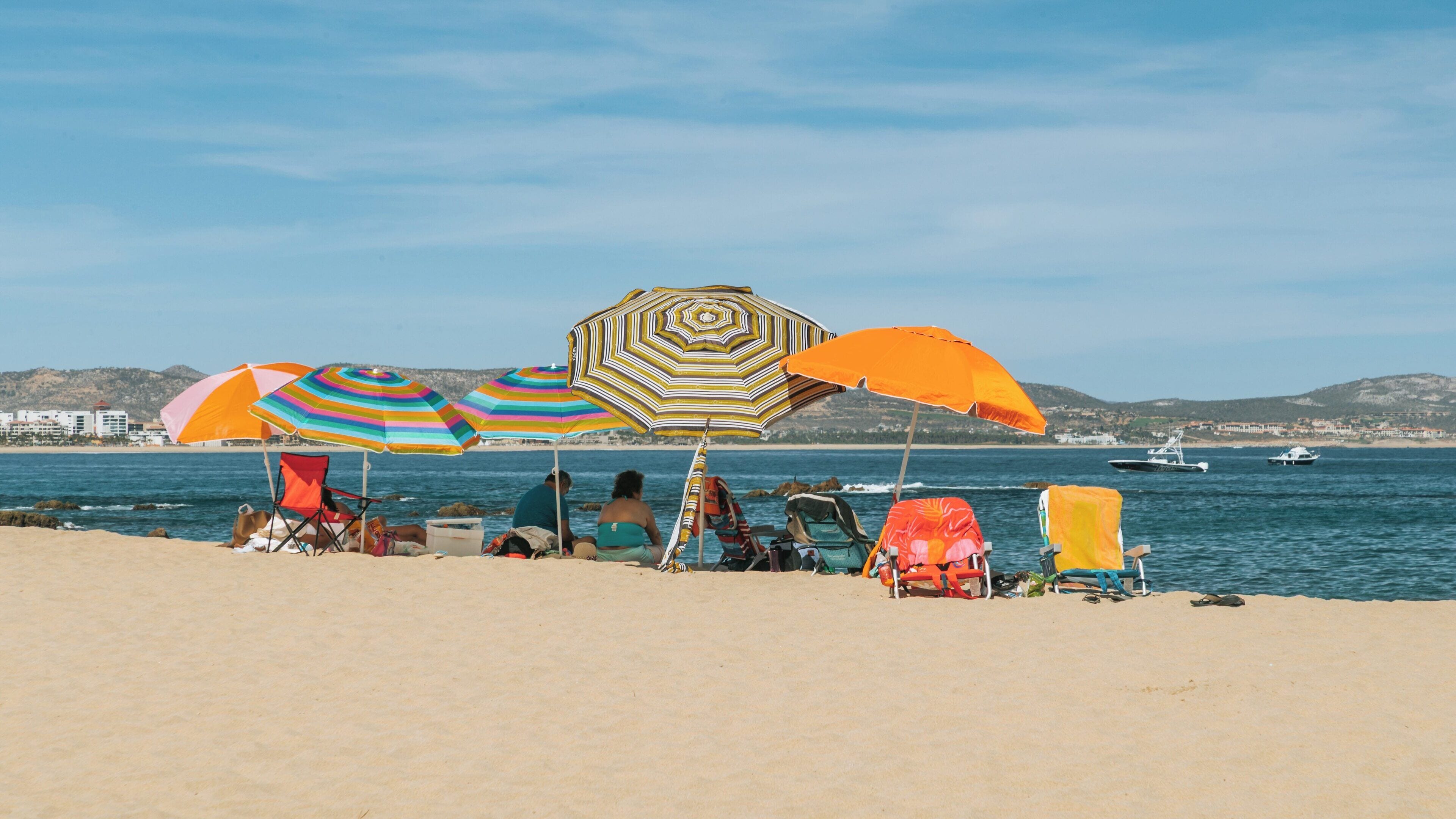 Palmilla Beach in San José del Cabo showcases vibrant umbrellas and families enjoying the sun along the beautiful shore of Baja California Sur, Mexico