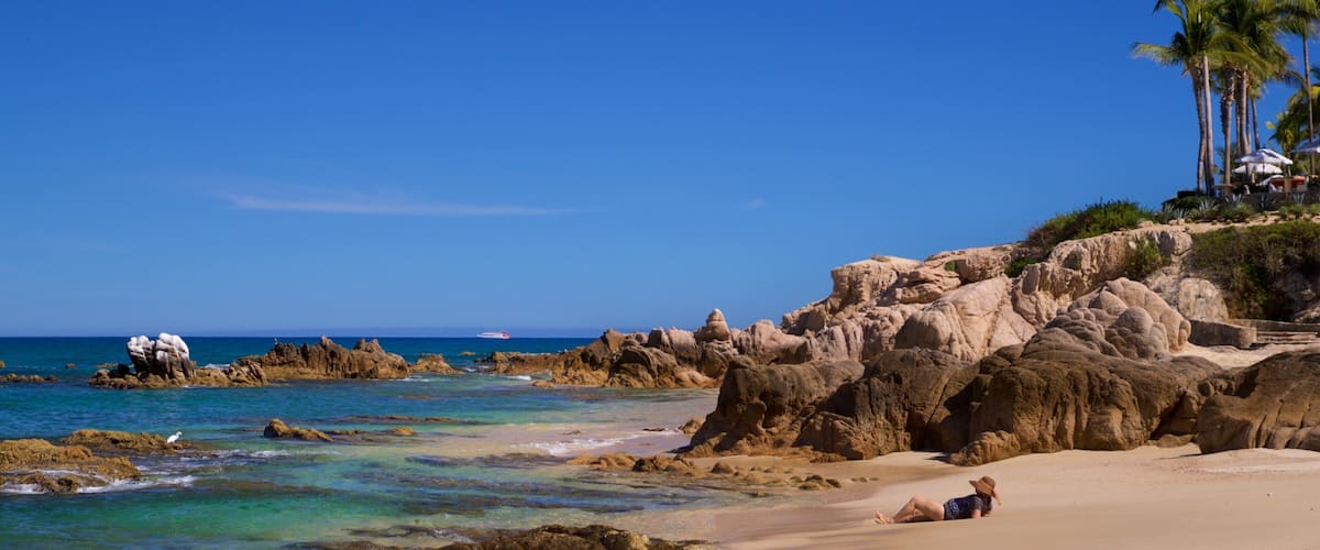 Palmilla Beach which includes a beach, rugged coastline and general coastal views