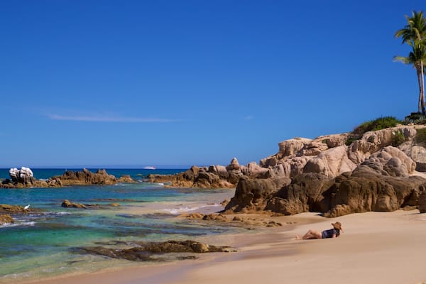 Palmilla Beach which includes a beach, rugged coastline and general coastal views
