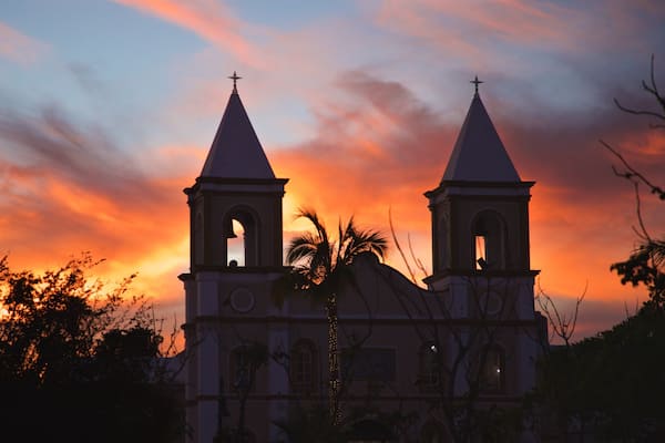 Mission of San Jose featuring a sunset and a church or cathedral