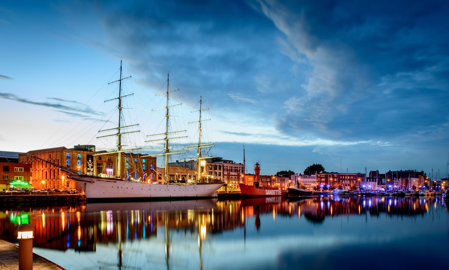 DUNKERQUE, FRANCE - JULY 22, 2017: Night falling on three historic ships in front of the port museum in the "bassin du commerce".
