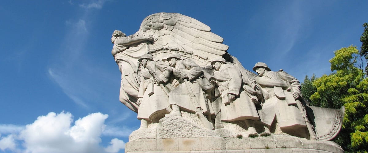 A stone monument with figures and wings.