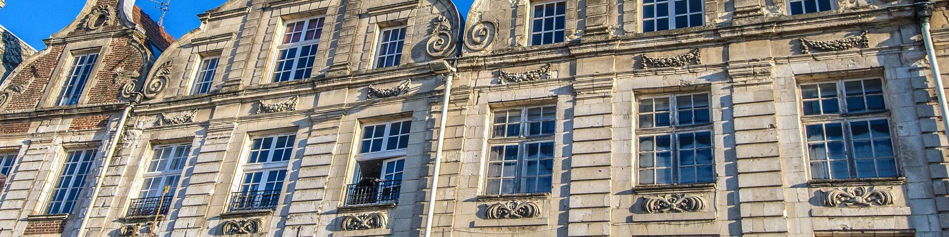 A historic building with ornate architectural details and multiple windows.