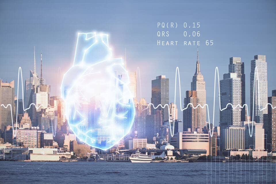 A city skyline with a prominent heart-shaped light installation in the foreground.
