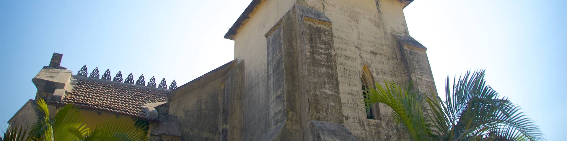 A church with a bell tower and a tiled roof.