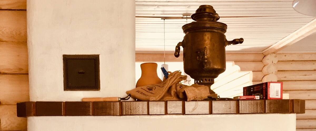 A brick oven fireplace with a pot on top, a towel, and a box.