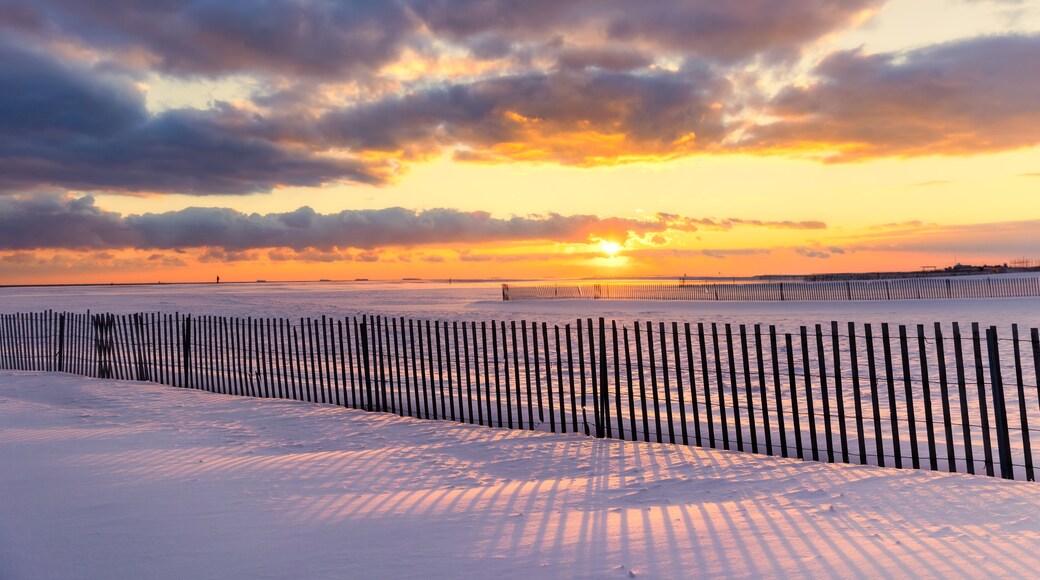 Shadows on a snow covered beach under golden sunset light. Jones Beach State Park - Wantagh New York