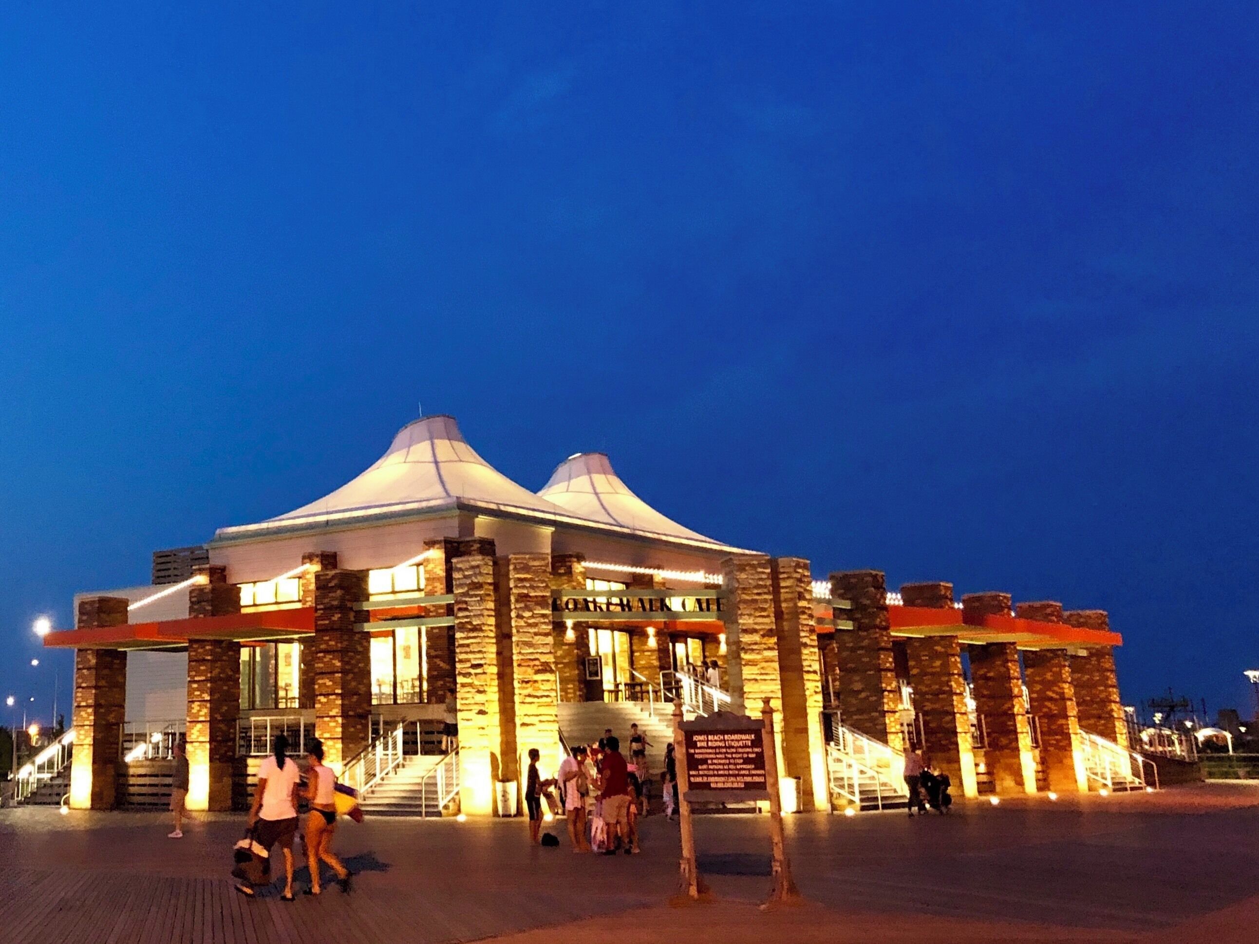 The store which is lining the side of the boardwalk in Jones Beach, built few years ago, now is getting popular and crowded in summer. The convenient services of the store not only regale people with enjoyment at the beach, but the structure of the building is also an attractive modern art. During the night time, with the glittering LEDs surrounding the building emit brilliant golden makes the store resplendent.