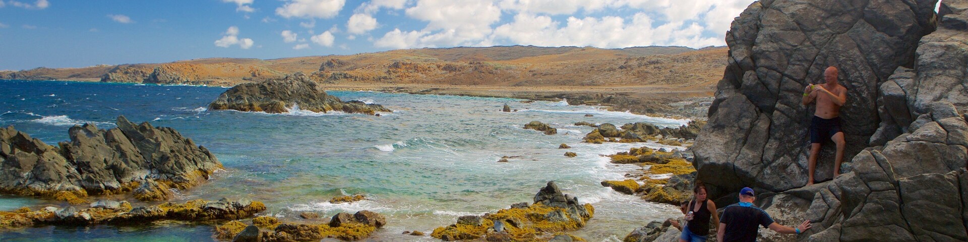 Conchi Natural Pool showing general coastal views as well as a small group of people