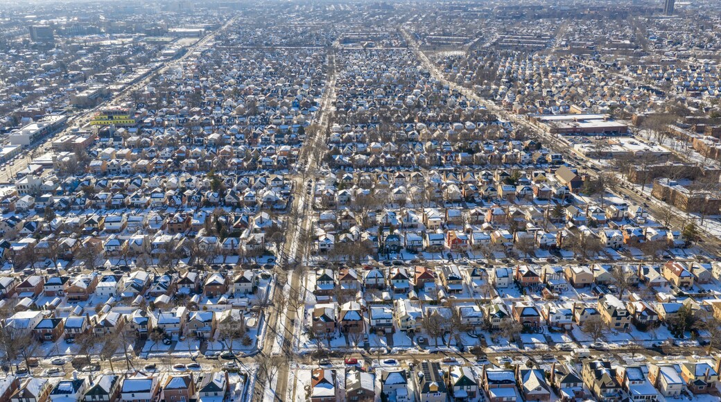 Fresh meadows queens residential neighborhood houses and streets covered in white snow and ice on a clear winter day, showing urban planning and community living in new york city