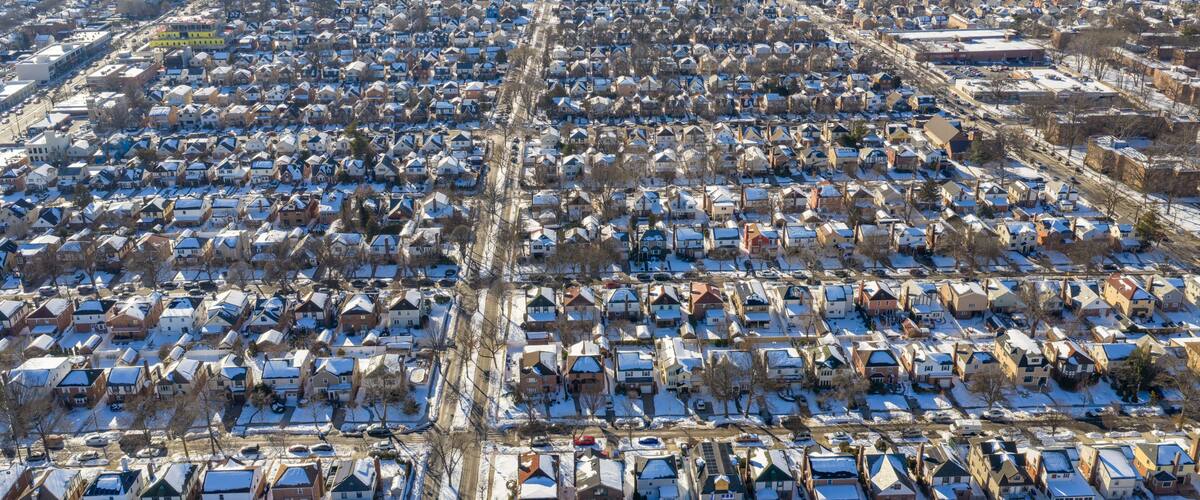 A densely packed residential area with snow-covered houses and streets.