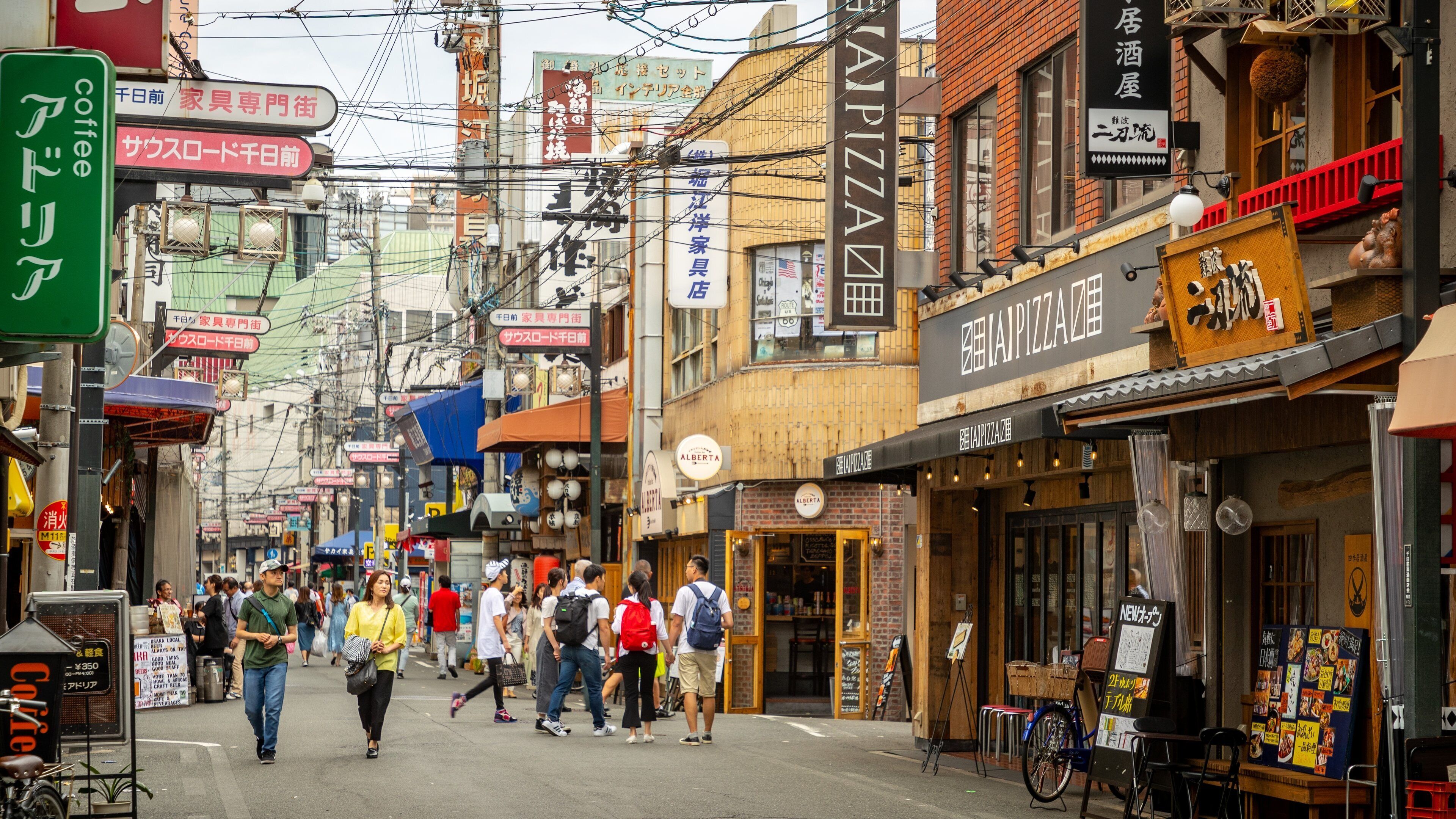 Shinsaibashi showing street scenes and a city as well as a couple