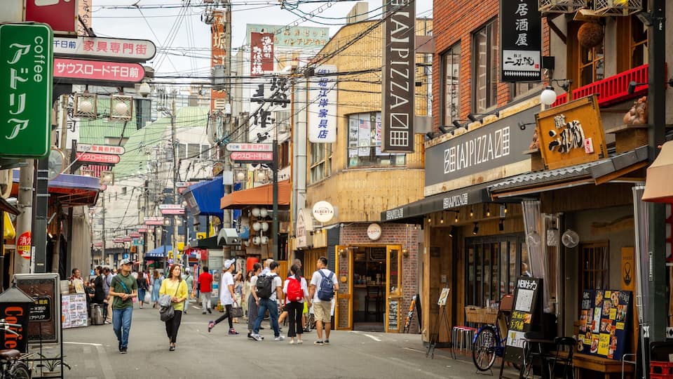 Shinsaibashi showing street scenes and a city as well as a couple