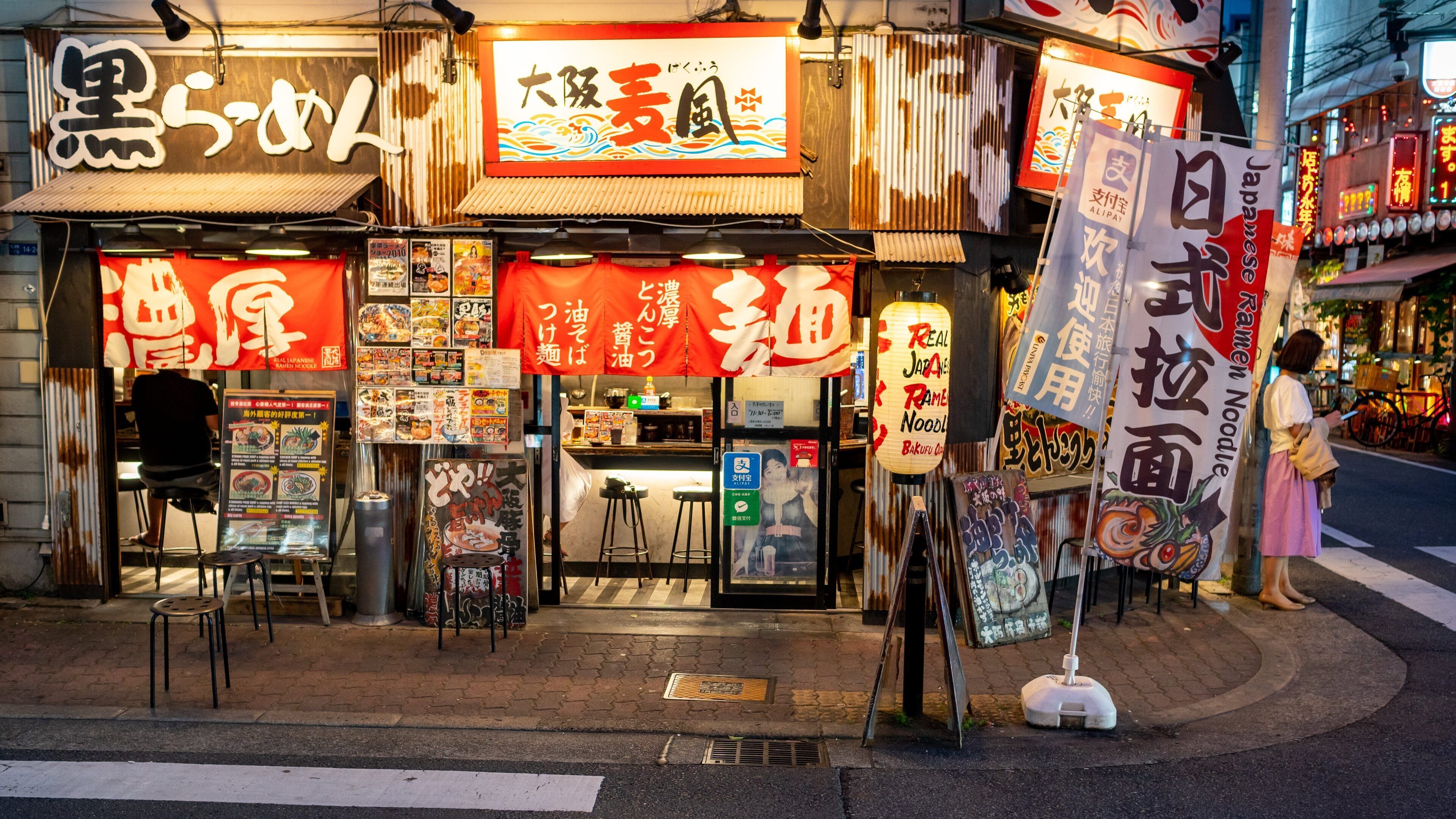 Shinsaibashi which includes street scenes and signage