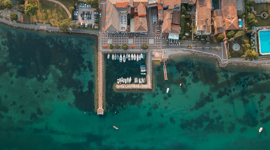 View of the picturesque turquoise waters of Cisano Harbour in Bardolino, Italy