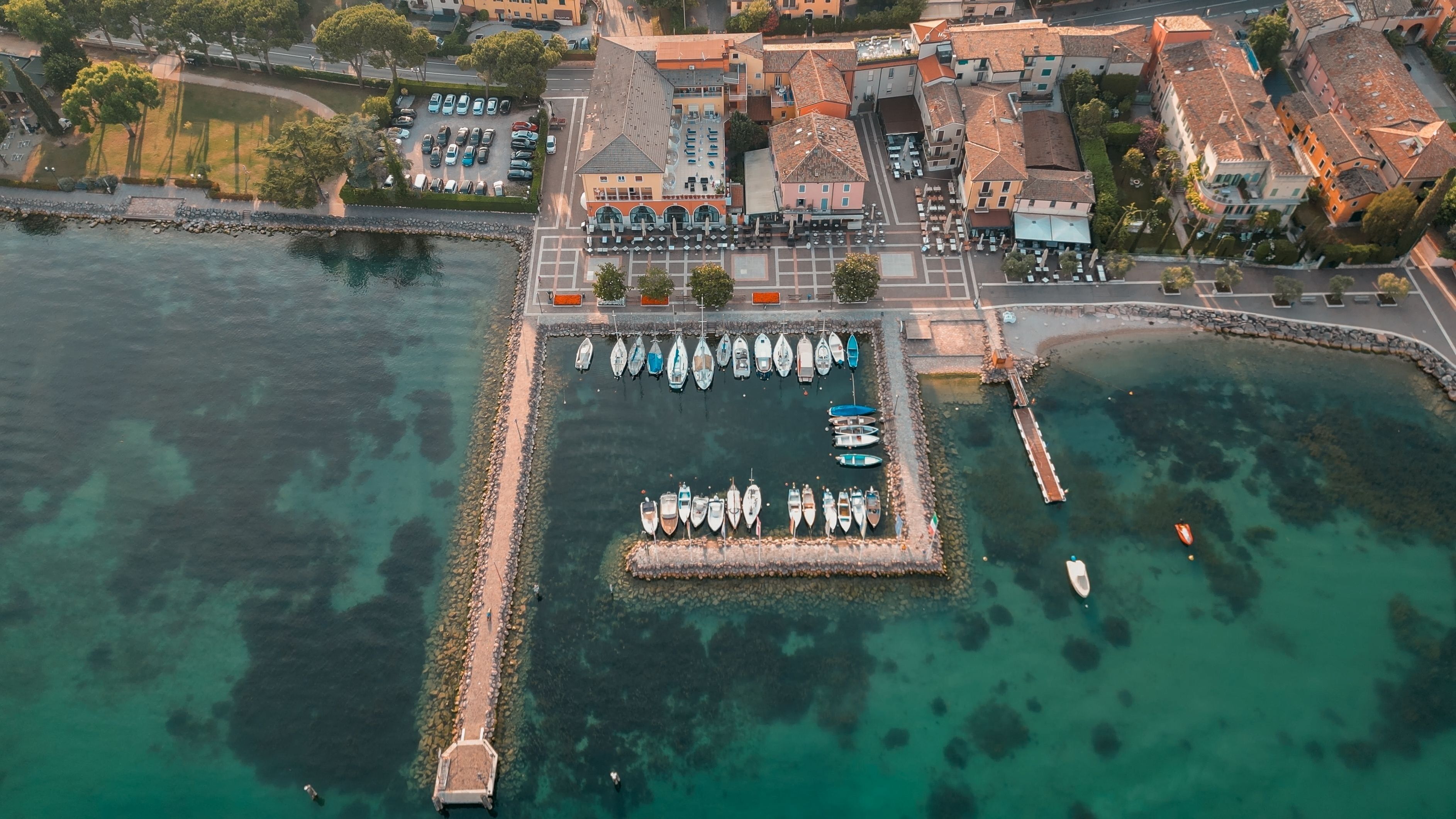 View of the picturesque turquoise waters of Cisano Harbour in Bardolino, Italy