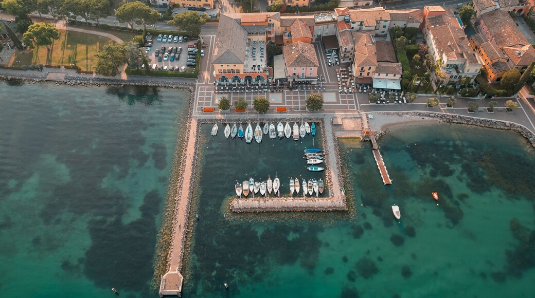 View of the picturesque turquoise waters of Cisano Harbour in Bardolino, Italy
