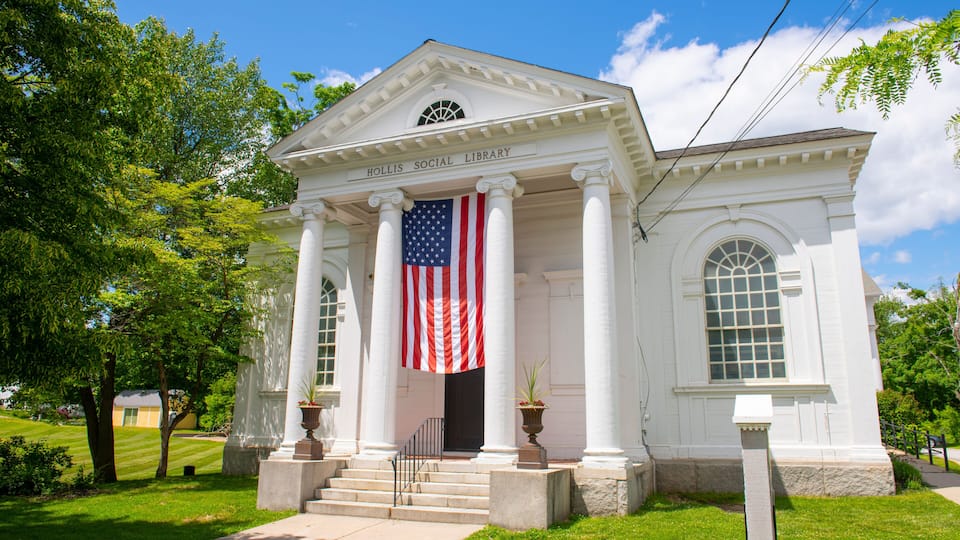A white building with columns and a flag, labeled "Hollis Social Library."