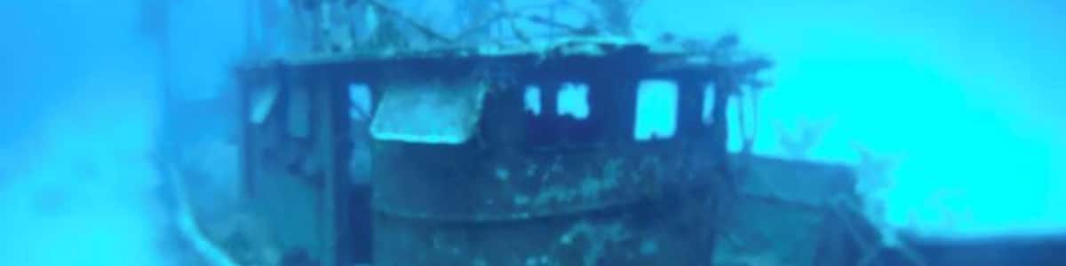 An underwater wreck with visible structural elements and debris.