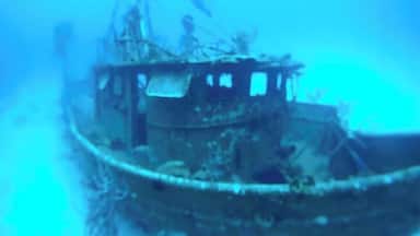 An underwater wreck with visible structural elements and debris.