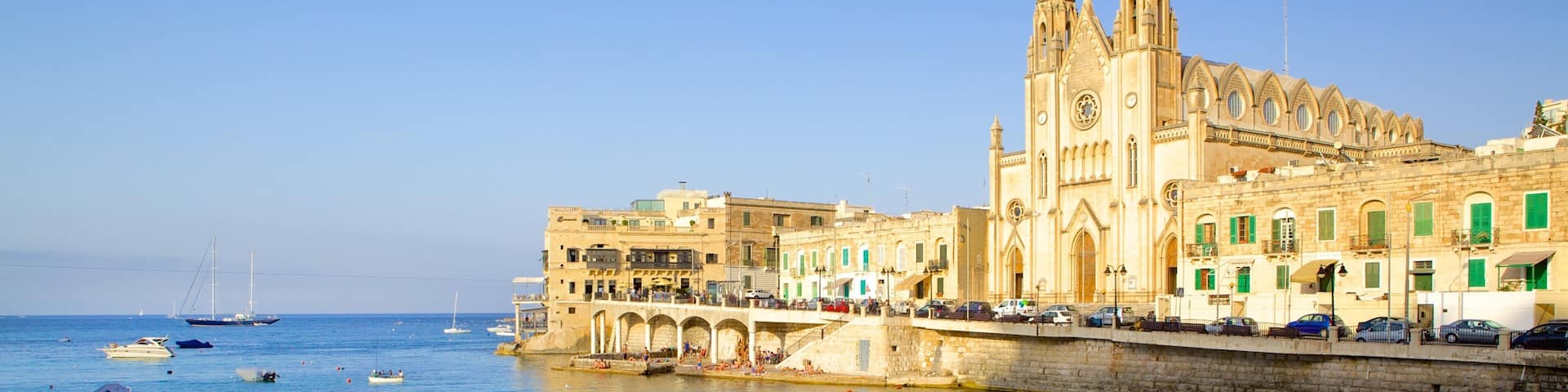 Balluta Bay which includes a church or cathedral, a coastal town and heritage architecture