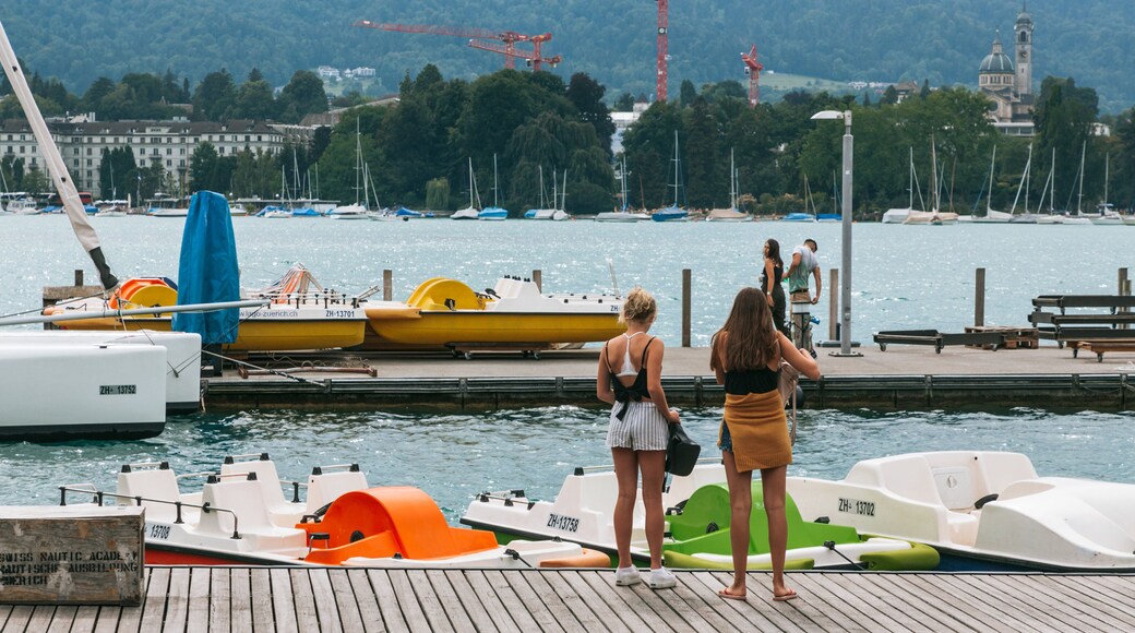Lakeside Promenade featuring a bay or harbor as well as an individual femail
