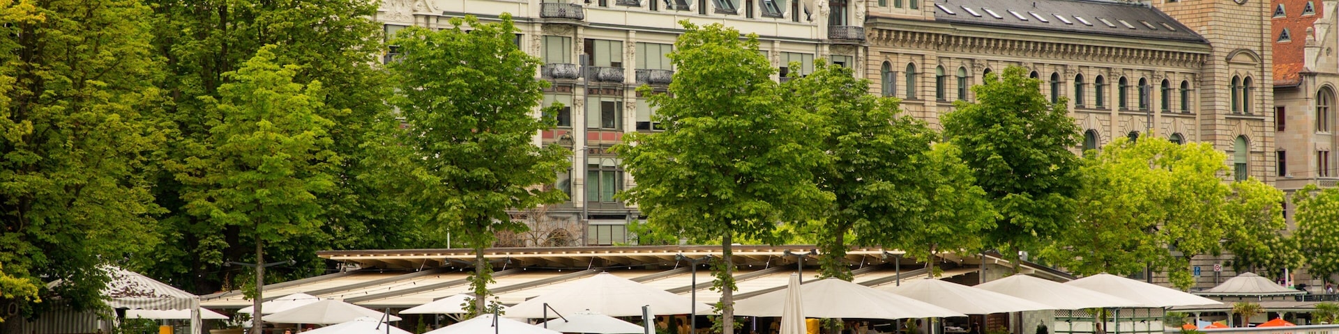 Lakeside Promenade featuring outdoor eating and a river or creek as well as a large group of people