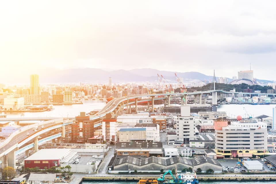 A cityscape with a river, bridges, and industrial buildings.