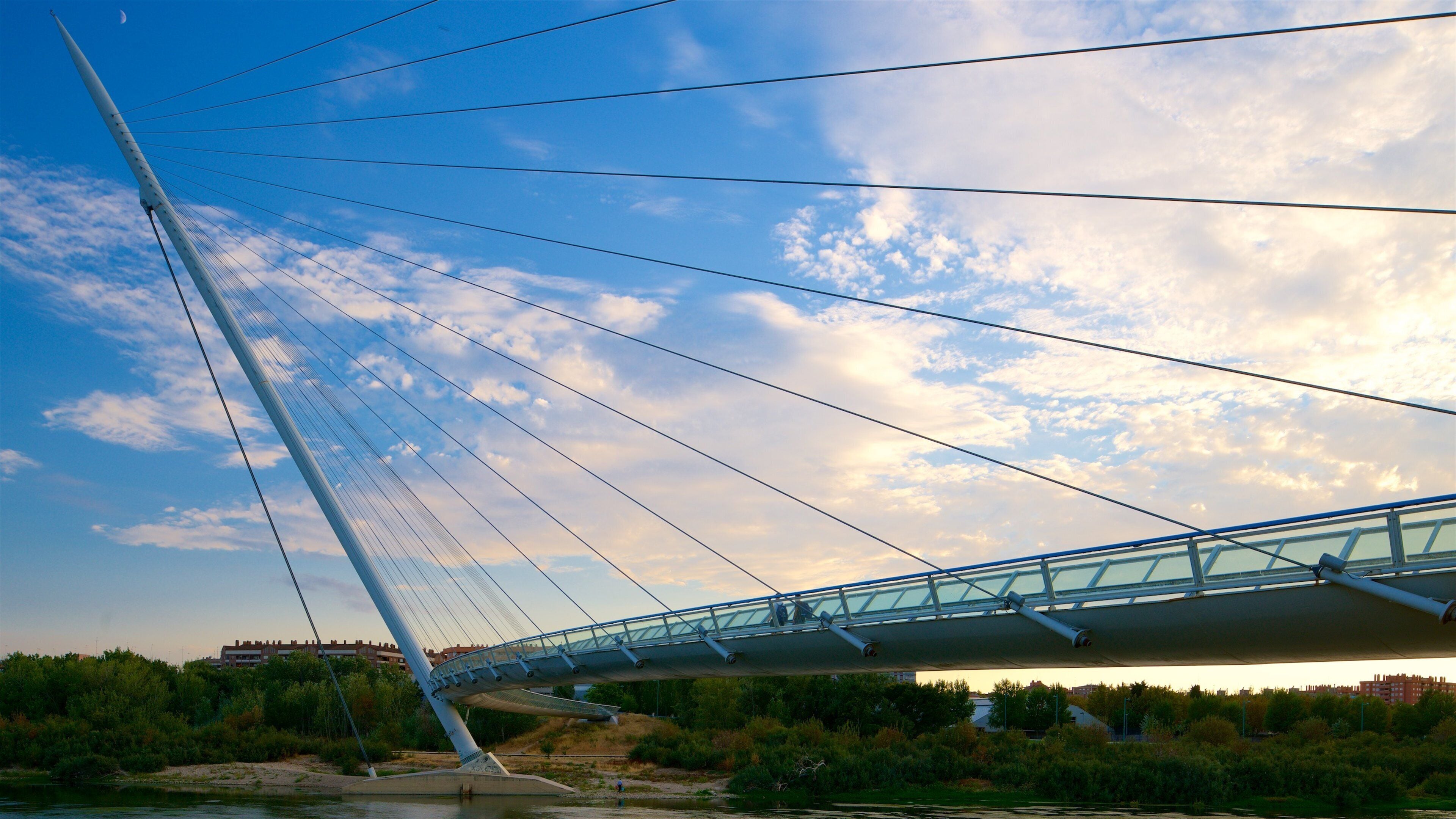 A cable-stayed bridge with a clear sky and clouds.