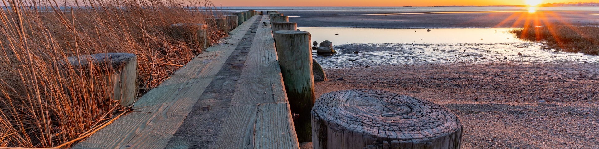 Breakwater at Harvey's Beach in Connecticut at sunset on a cloudless day